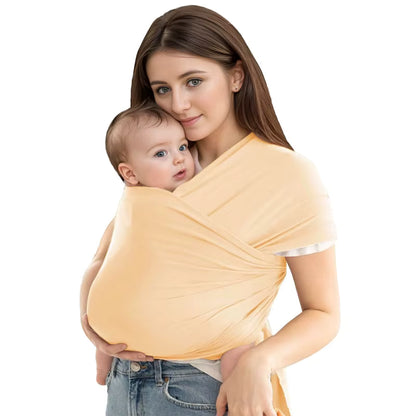 Mother wearing soft yellow baby wrap carrier with infant in secure wrap position, pastel color option